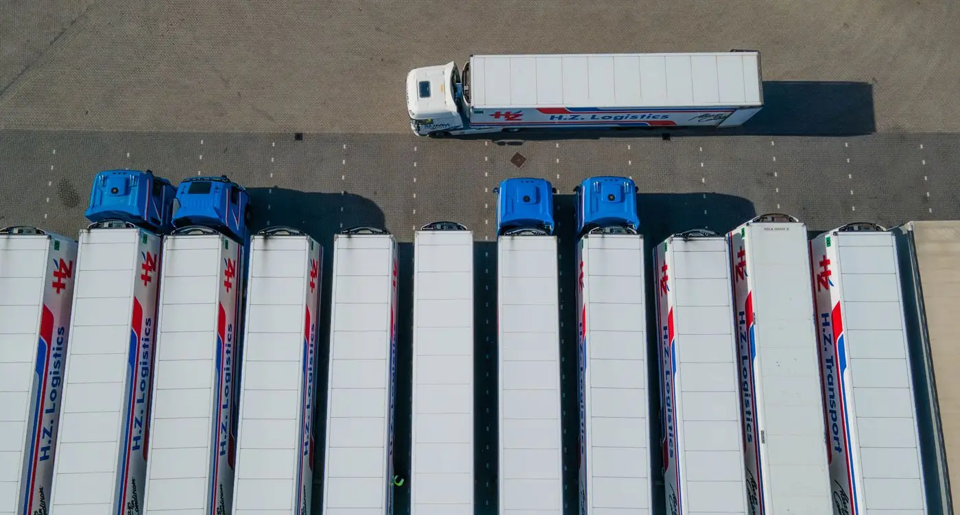 Aerial view of articulated lorries and trailers parked at a logistics depot